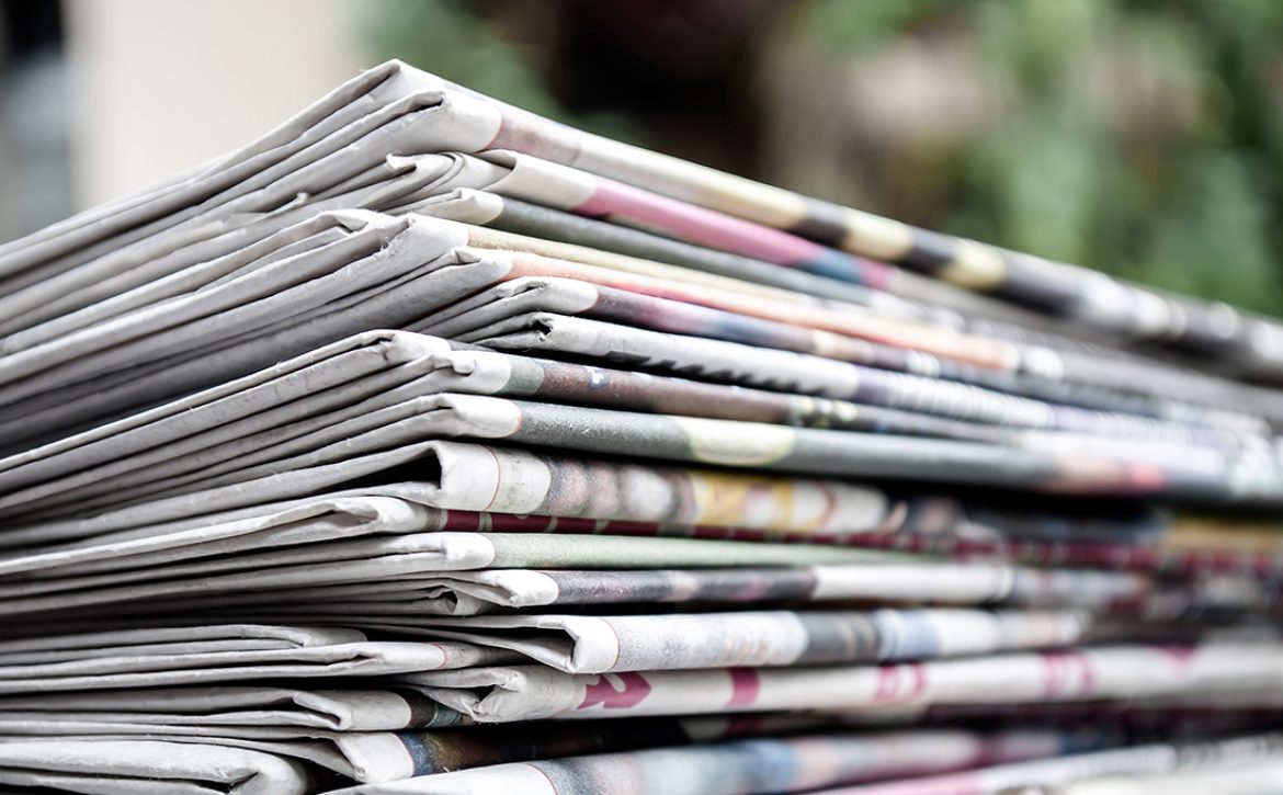 Newspapers,Folded,And,Stacked,On,The,Table,With,Garden,Or